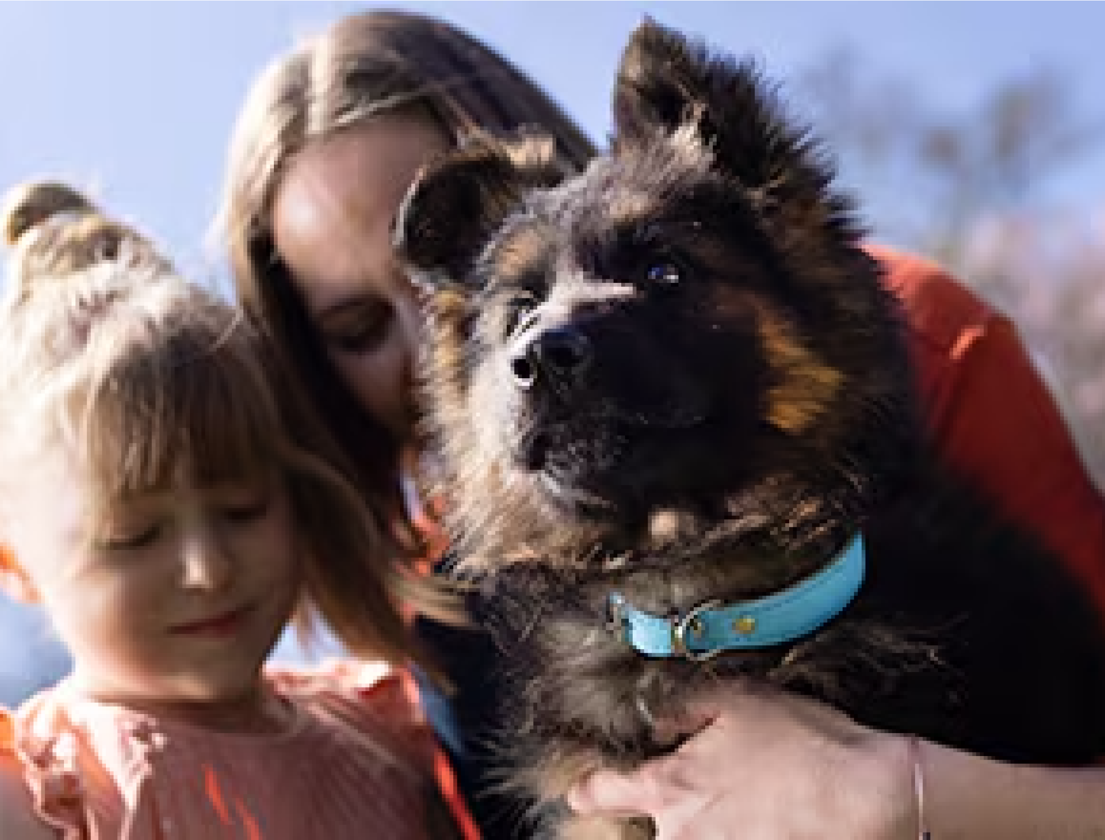 A woman and a girl holding a puppy